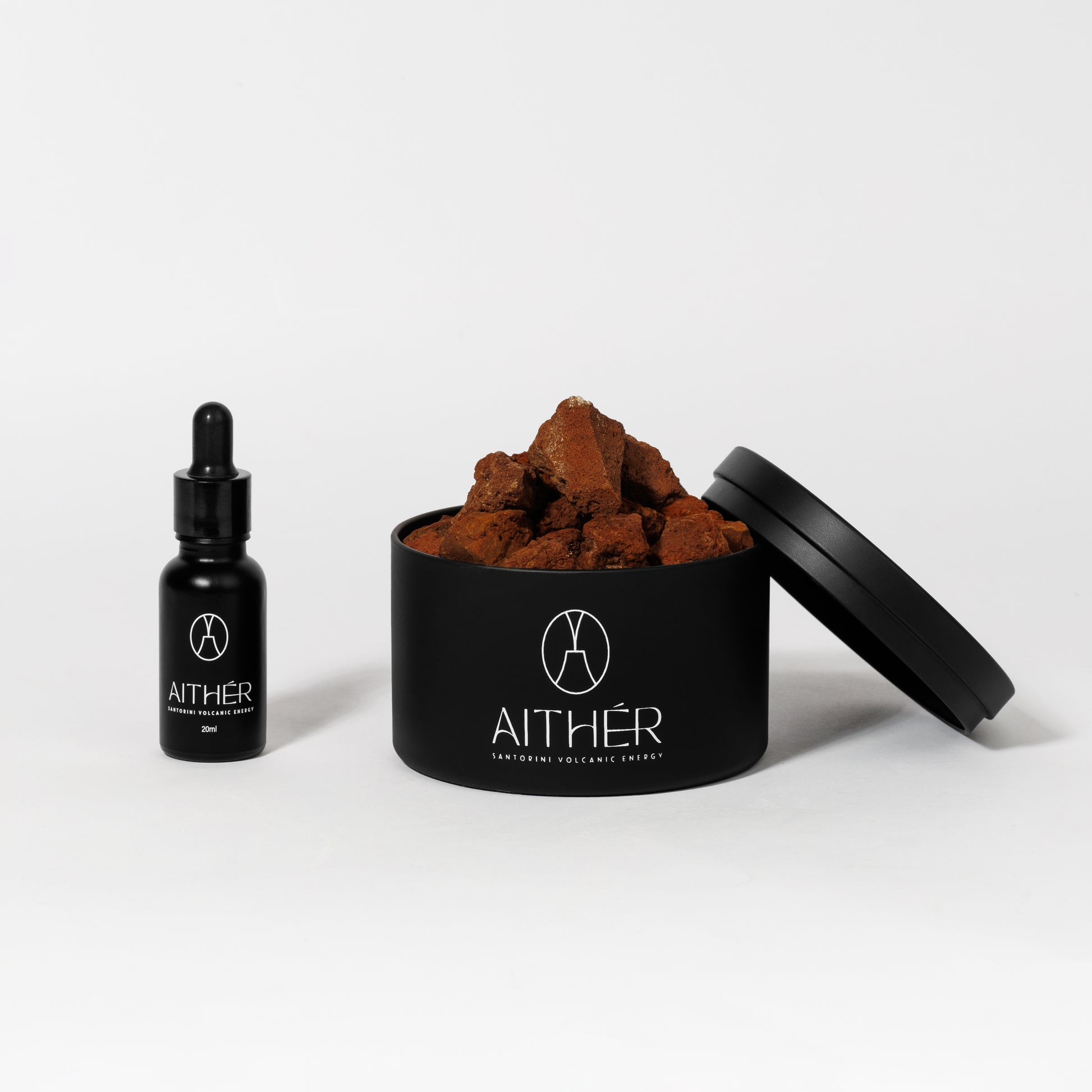 Aither Santorini volcanic stone diffuser with red lava stones and fragrance oil bottle