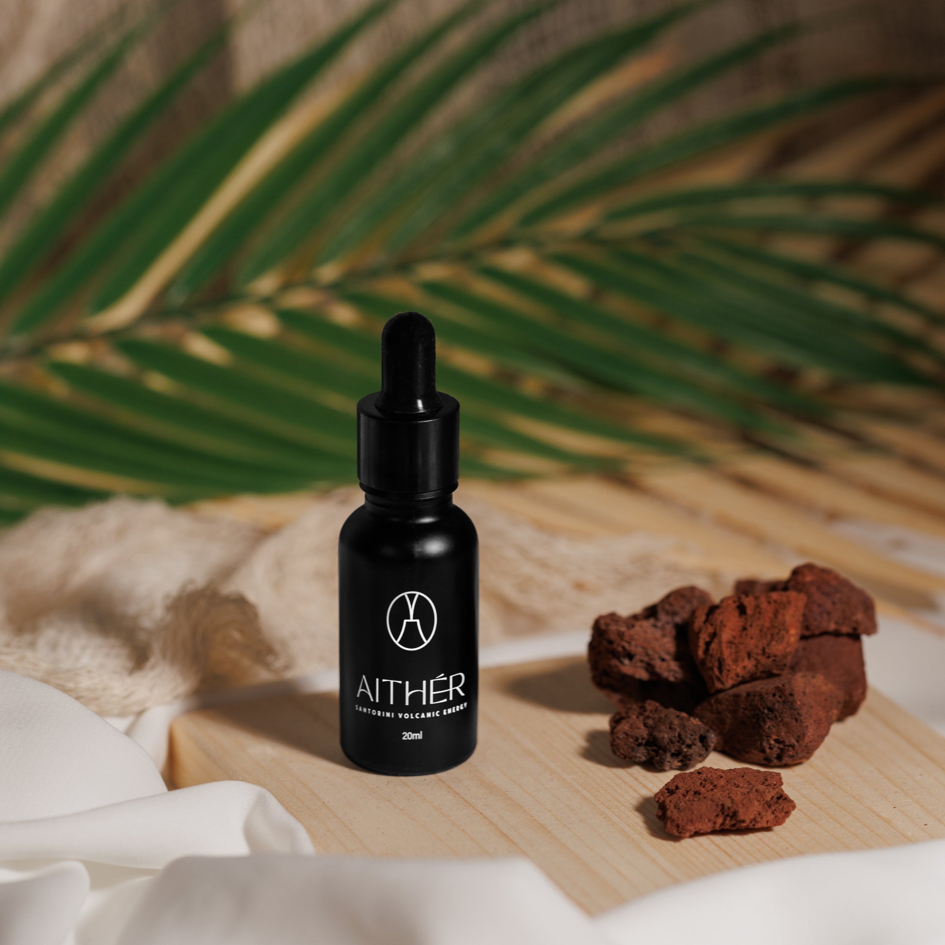 Aither Santorini volcanic stone diffuser with red lava stones and fragrance oil bottle
